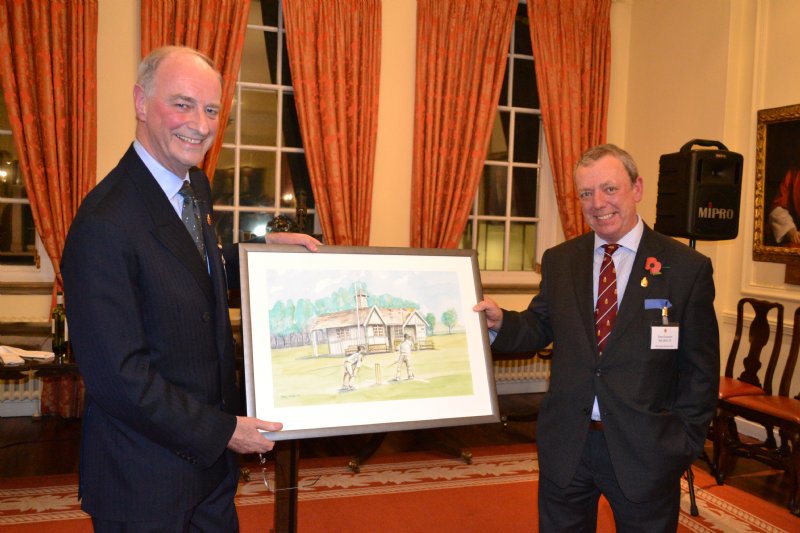 2014 OWA President Sir David Foskett presents Tony Crockert with a watercolour of the old cricket pavilion.
